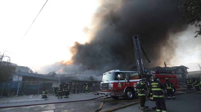 Hay al menos un fallecido: Bomberos lleva 15 horas trabajando en fatal incendio en bodegas de Macul